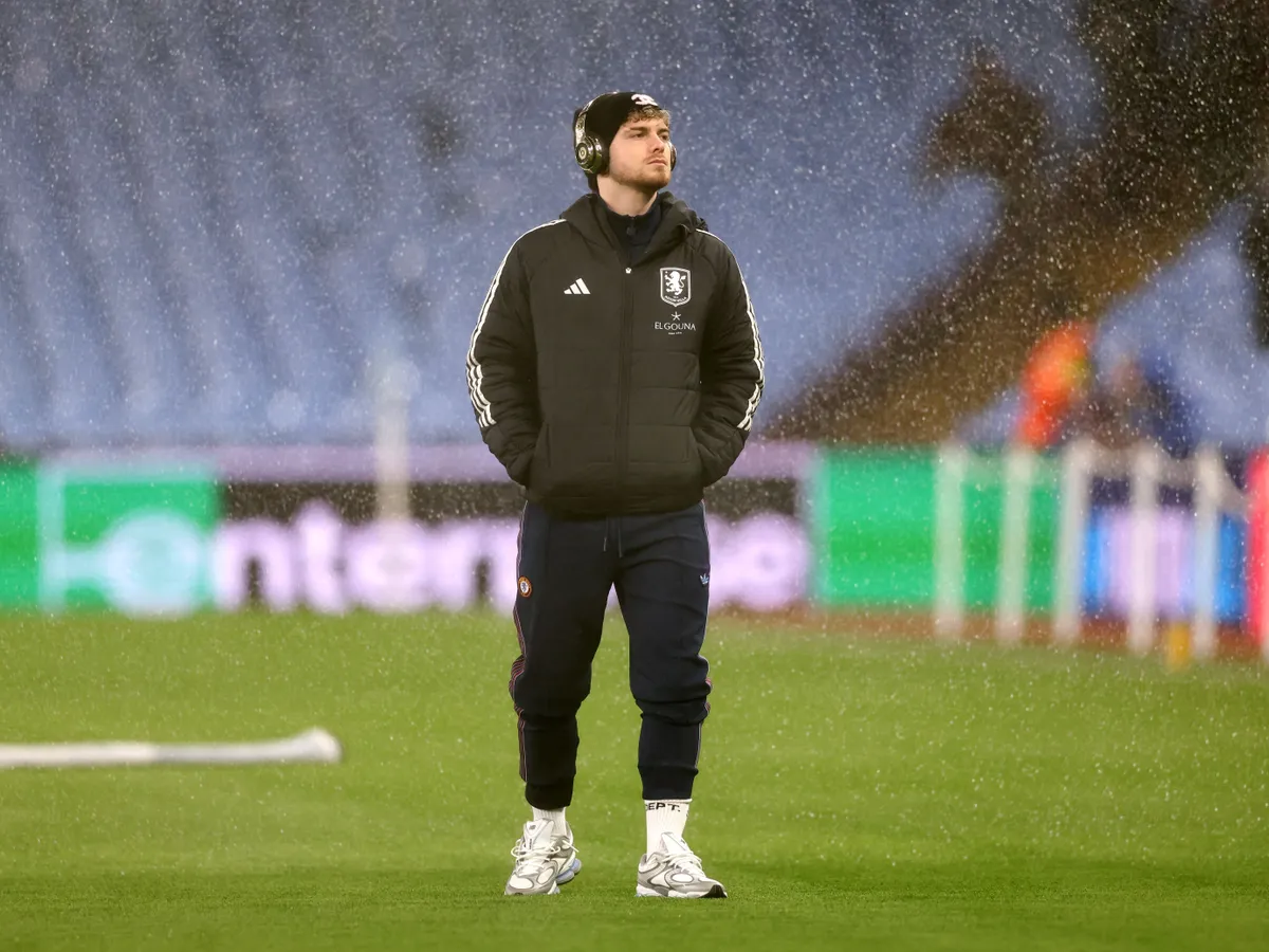Aston Villa's English striker #09 Harvey Elliott inspects the pitch as sprinklers release water before the UEFA Europa League league-stage football match between Aston Villa and RB Salzburg at Villa Park in Birmingham, central England on January 29, 2026. (Photo by Darren Staples / AFP)