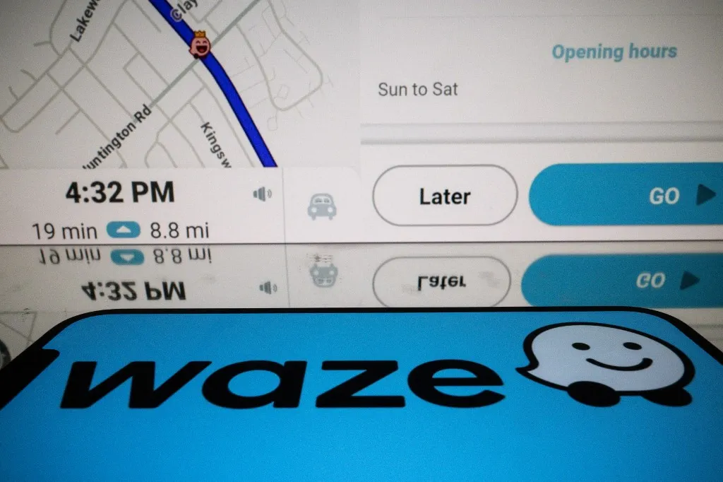 This photograph shows screens displaying the logo and the application Waze, a free navigation application in Toulouse, southern France, on January 15, 2025. (Photo by Lionel BONAVENTURE / AFP)