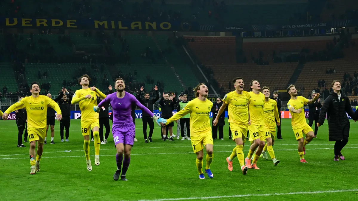 Bodo/Glimt's Nplayers celebrate their win at the end of the UEFA Champions League second-leg play-off football match between Inter Milan and Bodo/Glimt at San Siro stadium in Milan, northern Italy, on February 24, 2026. (Photo by PIERO CRUCIATTI / AFP)