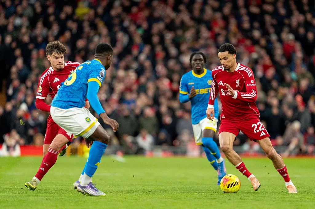 Liverpool's Hugo Ekitike takes on Wolverhampton Wanderers' Yerson Mosquera during the Premier League match between Liverpool and Wolverhampton Wanderers at Anfield in Liverpool, England, on December 27, 2025. (Photo by Steven Halliwell/MI News/NurPhoto) (Photo by MI News / NurPhoto via AFP)