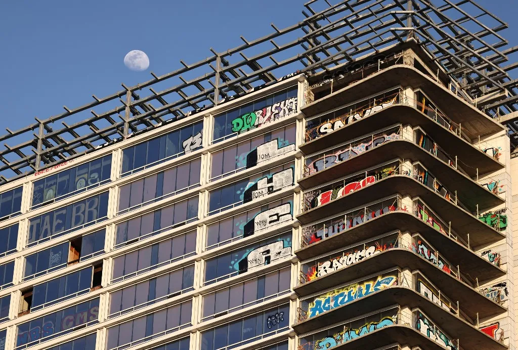 LOS ANGELES, CALIFORNIA - MARCH 20: A view of the so-called Graffiti Towers, where graffiti writers tagged 40 floors of an unfinished luxury skyscraper development last month, on March 20, 2024 in Los Angeles, California. Construction of the $1 billion Oceanwide Plaza luxury real estate development stalled in 2019 after a China-based developer ran out of funding leaving the three-tower project unfinished amid a housing crisis in the city. The project is located across the street from the Crypto.com Arena and its value has plummeted since its appraisal in 2017, according to the projects creditors. Some view the tagging as a work of graffiti art while city officials will pay nearly $4 million to secure the site and clean the graffiti. Mario Tama/Getty Images/AFP (Photo by MARIO TAMA / GETTY IMAGES NORTH AMERICA / Getty Images via AFP)