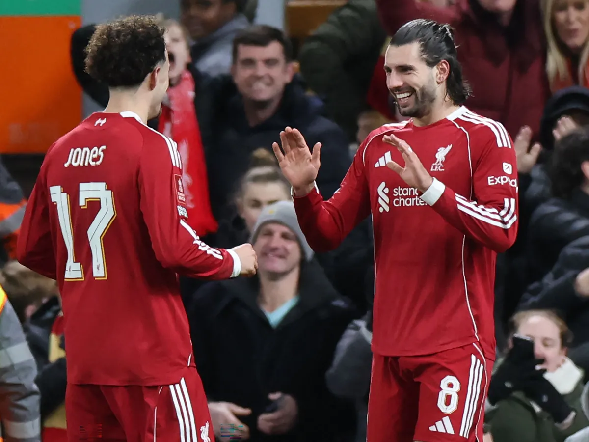 Liverpool's Hungarian midfielder #08 Dominik Szoboszlai (R) celebrates with Liverpool's English midfielder #17 Curtis Jones (L) after scoring their second goal during the English FA Cup fourth round football match between Liverpool and Brighton and Hove Albion at Anfield in Liverpool, north west England on February 14, 2026. (Photo by Darren Staples / AFP) / RESTRICTED TO EDITORIAL USE. No use with unauthorized audio, video, data, fixture lists, club/league logos or 'live' services. Online in-match use limited to 120 images. An additional 40 images may be used in extra time. No video emulation. Social media in-match use limited to 120 images. An additional 40 images may be used in extra time. No use in betting publications, games or single club/league/player publications. / 
