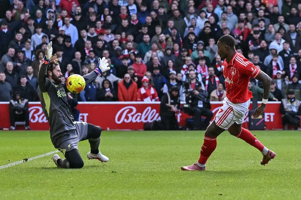 Liverpool's Brazilian goalkeeper #01 Alisson Becker (L) saves a shot by Nottingham Forest's English midfielder #07 Callum Hudson-Odoi (R) during the English Premier League football match between Nottingham Forest and Liverpool at The City Ground in Nottingham, central England on February 22, 2026. (Photo by Ben STANSALL / AFP) / RESTRICTED TO EDITORIAL USE. No use with unauthorized audio, video, data, fixture lists, club/league logos or 'live' services. Online in-match use limited to 120 images. An additional 40 images may be used in extra time. No video emulation. Social media in-match use limited to 120 images. An additional 40 images may be used in extra time. No use in betting publications, games or single club/league/player publications. / 