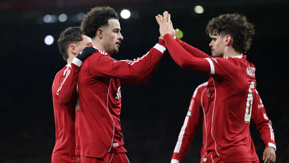 Liverpool's English midfielder #17 Curtis Jones (2L) celebrates  with Liverpool's Hungarian defender #06 Milos Kerkez (R) after scoring the opening goal of the English FA Cup fourth round football match between Liverpool and Brighton and Hove Albion at Anfield in Liverpool, north west England on February 14, 2026. (Photo by Darren Staples / AFP) / RESTRICTED TO EDITORIAL USE. No use with unauthorized audio, video, data, fixture lists, club/league logos or 'live' services. Online in-match use limited to 120 images. An additional 40 images may be used in extra time. No video emulation. Social media in-match use limited to 120 images. An additional 40 images may be used in extra time. No use in betting publications, games or single club/league/player publications. / 