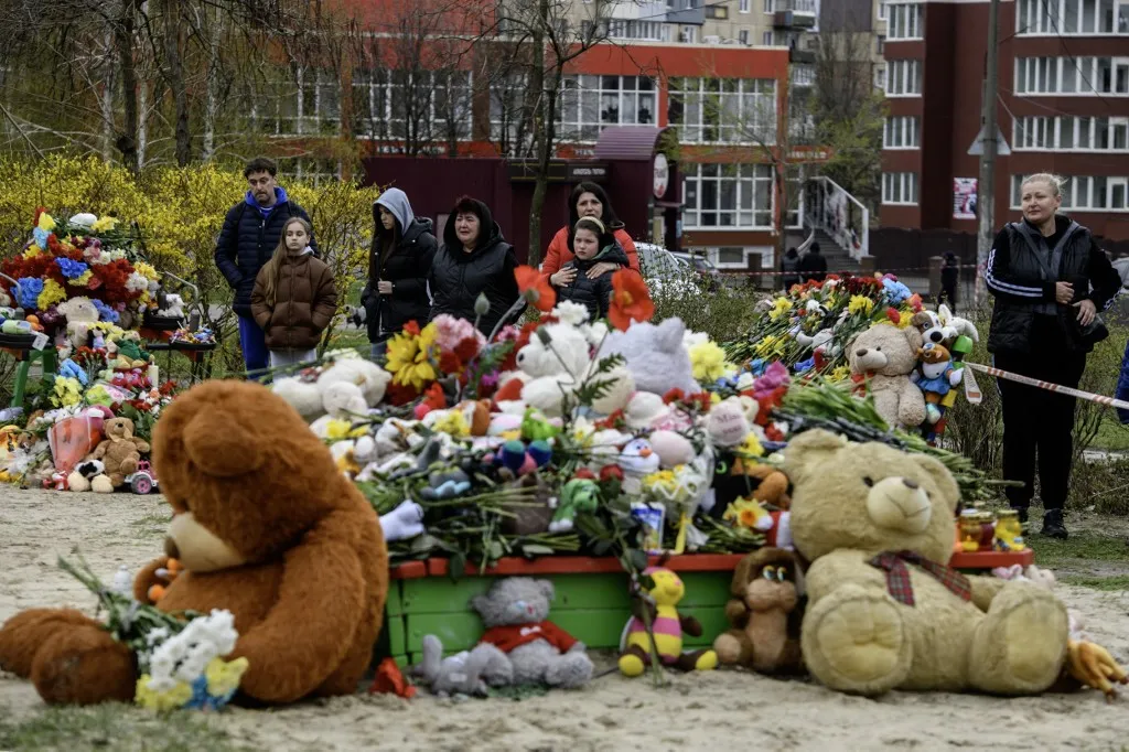 People bring flowers and toys en masse to a playground in Kryvyi Rih, Ukraine, on April 6, 2025, where nine children die in a Russian ballistic missile strike. The attack on the residential neighborhood claims 20 lives in total. (Photo by Maxym Marusenko/NurPhoto) (Photo by Maxym Marusenko / NurPhoto via AFP)