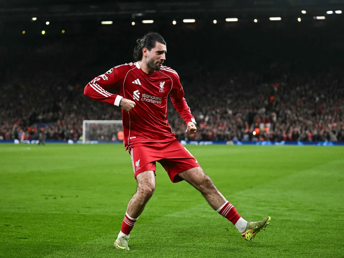 Liverpool's Hungarian midfielder #08 Dominik Szoboszlai celebrates scoring his team's first goal during the UEFA Champions League, round of 16 second leg football match between Liverpool and Galatasaray at Anfield in Liverpool, north-west England on March 18, 2026. (Photo by Paul ELLIS / AFP)