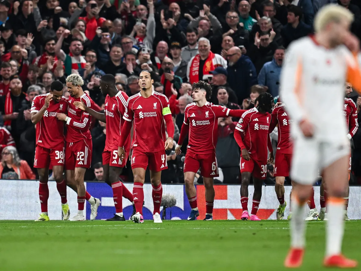 Liverpool's Dutch midfielder #38 Ryan Gravenberch (L) celebrates with teammates after scoring his team's third goal during the UEFA Champions League, round of 16 second leg football match between Liverpool and Galatasaray at Anfield in Liverpool, north-west England on March 18, 2026. (Photo by Paul ELLIS / AFP)