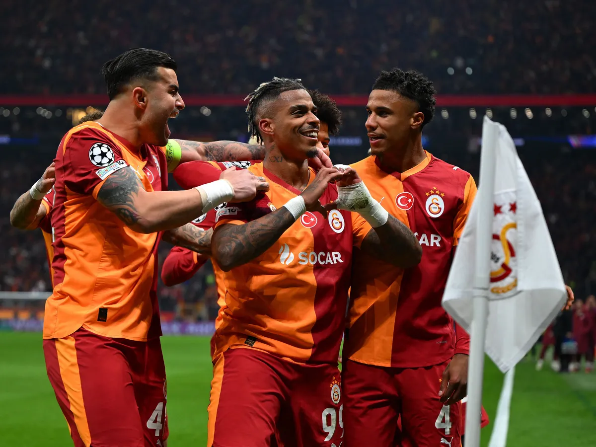 Galatasaray's Gabonese midfielder #99 Mario Lemina (C) celebrates with teammates after scoring the opening goal during the UEFA Champions League round of 16 first leg football match between Galatasaray SK and Liverpool FC at the Ali Sami Yen Sports Complex in Istanbul on March 10, 2026. (Photo by YASIN AKGUL / AFP)