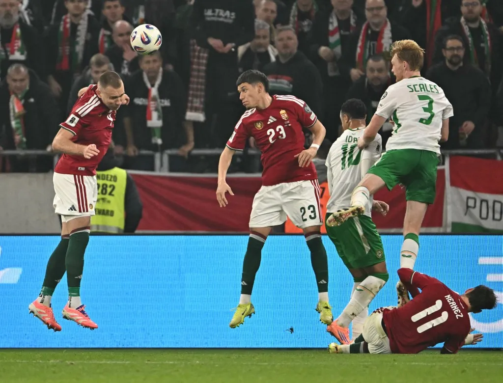 Hungary's defender #04 Attila Szalai (L) heads the ball during the FIFA World Cup 2026 Group F European qualification football match betweem Hungary and Republic of Ireland at the Puskas Arena in Budapest, Hungary on November 16, 2025. (Photo by Attila KISBENEDEK / AFP)