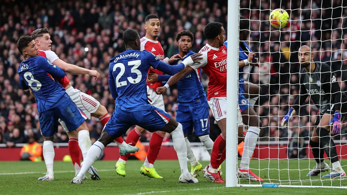 Arsenal's French defender #02 William Saliba (behind C) scores the team's first goal during the English Premier League football match between Arsenal and Chelsea at the Emirates Stadium in London on March 1, 2026. (Photo by Adrian Dennis / AFP) / RESTRICTED TO EDITORIAL USE. No use with unauthorized audio, video, data, fixture lists, club/league logos or 'live' services. Online in-match use limited to 120 images. An additional 40 images may be used in extra time. No video emulation. Social media in-match use limited to 120 images. An additional 40 images may be used in extra time. No use in betting publications, games or single club/league/player publications. / 