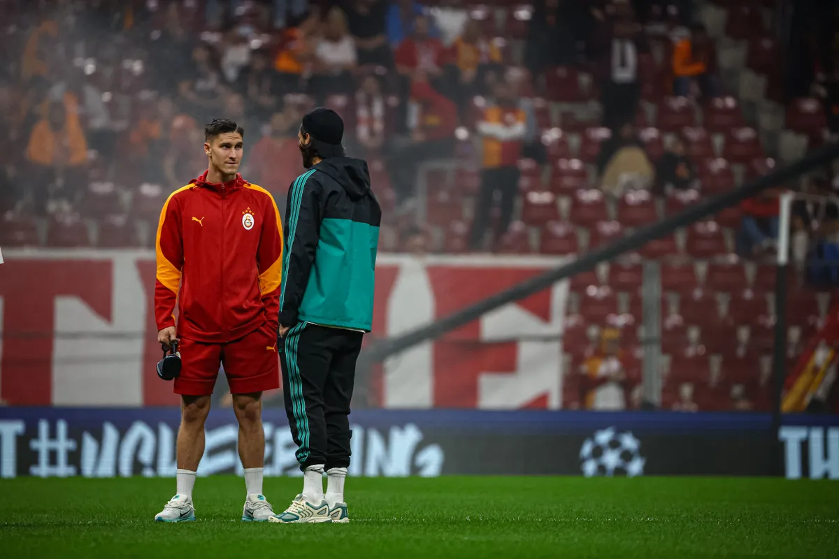 Roland Sallai of Galatasaray SK talks with Liverpool player before the match. Galatasaray SK and Liverpool FC faced each other at UEFA Champions League 2025/26 League Phase MD2. The match took place in Ali Sami Yen Rams Park Stadium on September 30, 2025. (Photo by Burak Basturk / Middle East Images via AFP)