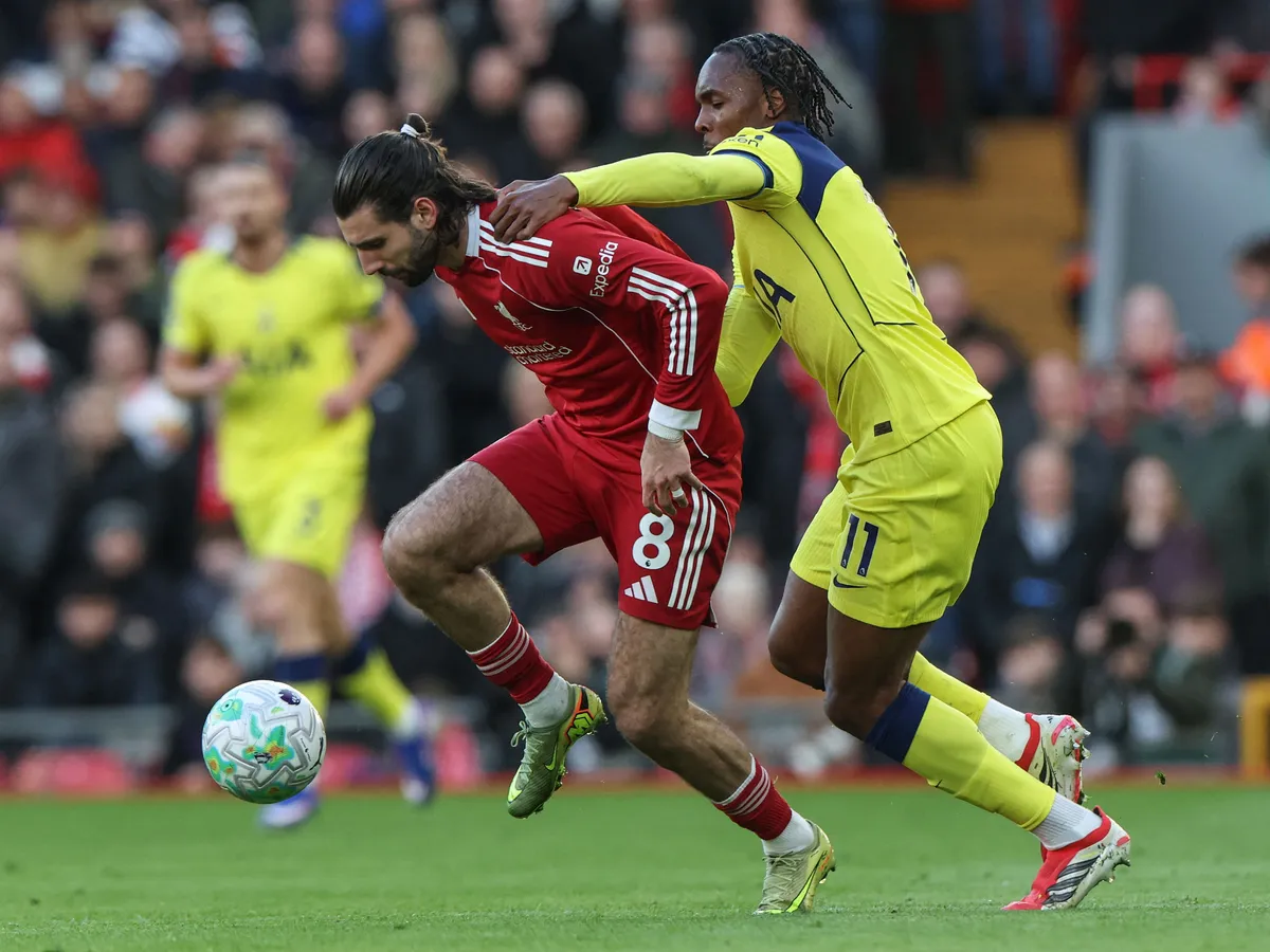 Liverpool's Hungarian midfielder #08 Dominik Szoboszlai (L) is challenged by Tottenham Hotspur's French midfielder #11 Mathys Tel (R) during the English Premier League football match between Liverpool and Tottenham Hotspur at Anfield in Liverpool, north west England on March 15, 2026. (Photo by Darren Staples / AFP) / RESTRICTED TO EDITORIAL USE. No use with unauthorized audio, video, data, fixture lists, club/league logos or 'live' services. Online in-match use limited to 120 images. An additional 40 images may be used in extra time. No video emulation. Social media in-match use limited to 120 images. An additional 40 images may be used in extra time. No use in betting publications, games or single club/league/player publications. / 