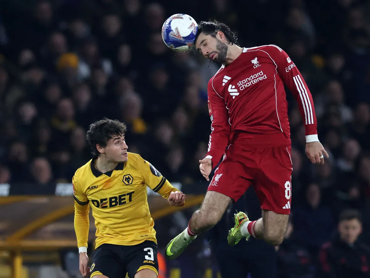 Liverpool's Hungarian midfielder #08 Dominik Szoboszlai (R) vies with Wolverhampton Wanderers' Spanish defender #03 Hugo Bueno (L) during the English FA Cup fifth round football match between Wolverhampton Wanderers and Liverpool at the Molineux stadium in Wolverhampton, central England on March 6, 2026. (Photo by Darren Staples / AFP) / RESTRICTED TO EDITORIAL USE. No use with unauthorized audio, video, data, fixture lists, club/league logos or 'live' services. Online in-match use limited to 120 images. An additional 40 images may be used in extra time. No video emulation. Social media in-match use limited to 120 images. An additional 40 images may be used in extra time. No use in betting publications, games or single club/league/player publications. / 