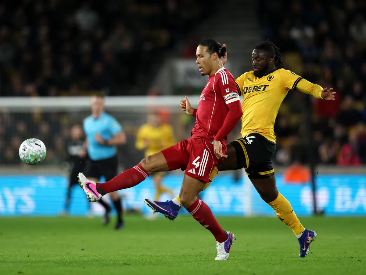 Liverpool's Dutch defender #04 Virgil van Dijk is put under pressure by Wolverhampton Wanderers' Nigerian striker #14 Tolu Arokodare during the English Premier League football match between Wolverhampton Wanderers and Liverpool at the Molineux stadium in Wolverhampton, central England on March 3, 2026. (Photo by Darren Staples / AFP) / RESTRICTED TO EDITORIAL USE. No use with unauthorized audio, video, data, fixture lists, club/league logos or 'live' services. Online in-match use limited to 120 images. An additional 40 images may be used in extra time. No video emulation. Social media in-match use limited to 120 images. An additional 40 images may be used in extra time. No use in betting publications, games or single club/league/player publications. / 