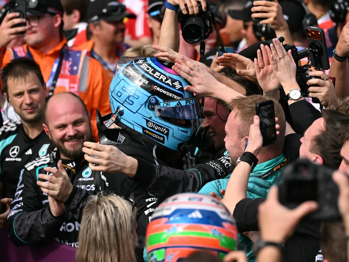 Mercedes' British driver George Russell (C) celebrates winning the Formula One Australian Grand Prix at the Albert Park Circuit in Melbourne on March 8, 2026. (Photo by WILLIAM WEST / AFP) / -- IMAGE RESTRICTED TO EDITORIAL USE - STRICTLY NO COMMERCIAL USE --