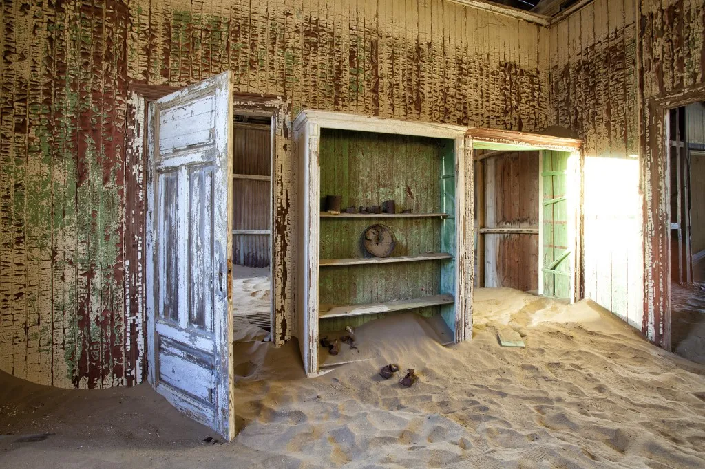 Interior of building slowly being consumed by the sands of the Namib Desert in the abandoned former German diamond mining town of Kolmanskop, Forbidden Diamond Area near Luderitz, Namibia, Africa (Photo by Lee Frost / Robert Harding Premium / robertharding via AFP)