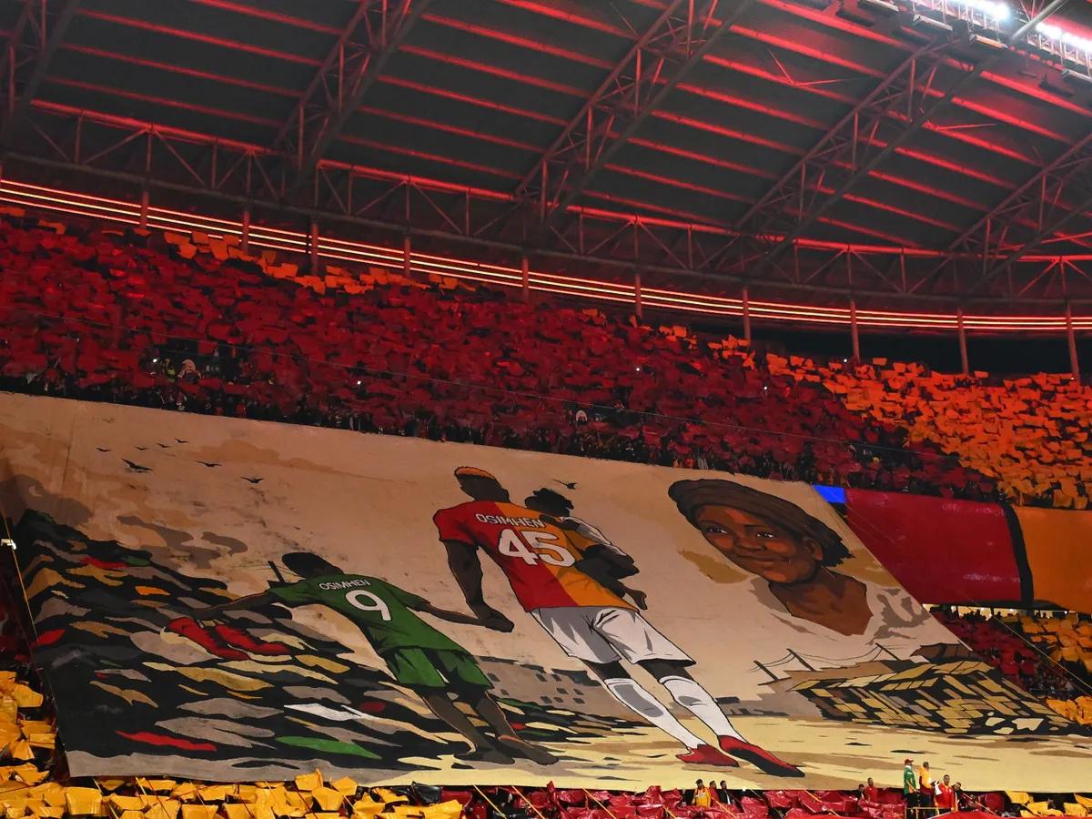 Liverpool supporters display a giant tifo in honour of Galatasaray's Nigerian forward #45 Victor Osimhen and his late mother during the UEFA Champions League round of 16 first leg football match between Galatasaray SK and Liverpool FC at the Ali Sami Yen Sports Complex in Istanbul on March 10, 2026. (Photo by YASIN AKGUL / AFP)