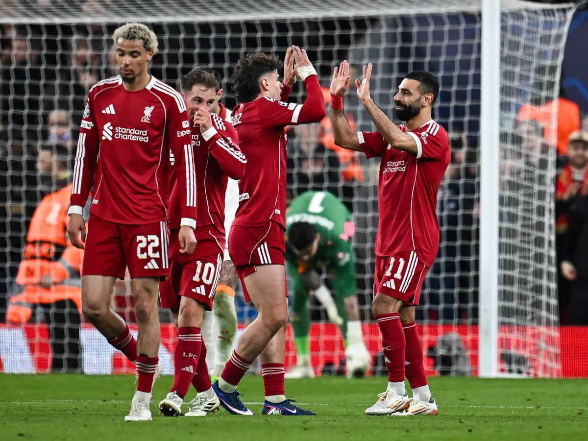 Liverpool's Egyptian forward #11 Mohamed Salah (R) celebrates scoring his team's fourth goal during the UEFA Champions League, round of 16 second leg football match between Liverpool and Galatasaray at Anfield in Liverpool, north-west England on March 18, 2026. (Photo by Paul ELLIS / AFP)