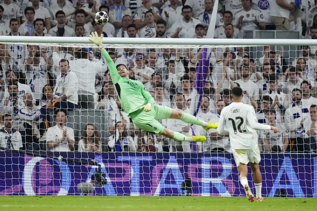 Thibaut Courtois goalkeeper of Real Madrid and Belgium makes a save during the UEFA Champions League 2025/26 League Knockout Play-off Second Leg match between Real Madrid C.F. and SL Benfica at Estadio Santiago Bernabeu on February 25, 2026 in Madrid, Spain. (Photo by Jose Breton/Pics Action/NurPhoto) (Photo by Jose Breton / NurPhoto via AFP)