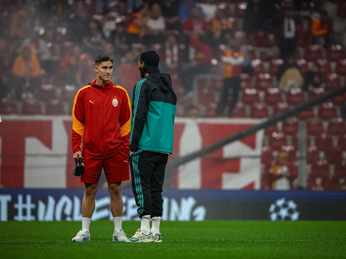 Roland Sallai of Galatasaray SK talks with Liverpool player before the match. Galatasaray SK and Liverpool FC faced each other at UEFA Champions League 2025/26 League Phase MD2. The match took place in Ali Sami Yen Rams Park Stadium on September 30, 2025. (Photo by Burak Basturk / Middle East Images via AFP)