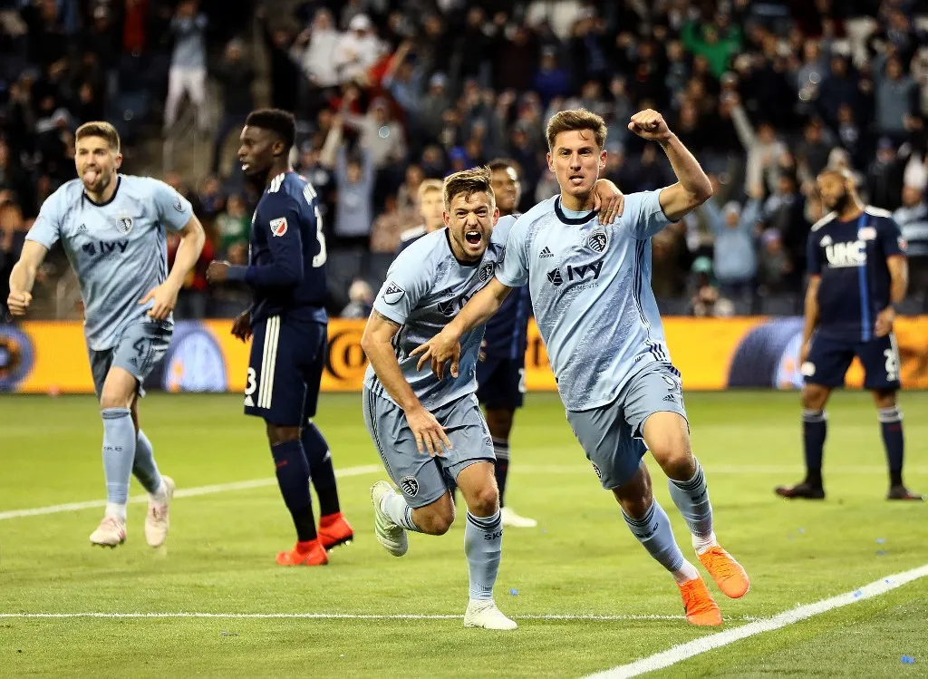 KANSAS CITY, KANSAS - APRIL 27: Krisztian Nemeth #9 of Sporting Kansas City celebrates with Kelyn Rowe #11 after scoring during the second half of the game against the New England Revolution at Children's Mercy Park on April 27, 2019 in Kansas City, Kansas.   Jamie Squire/Getty Images/AFP (Photo by JAMIE SQUIRE / GETTY IMAGES NORTH AMERICA / Getty Images via AFP)