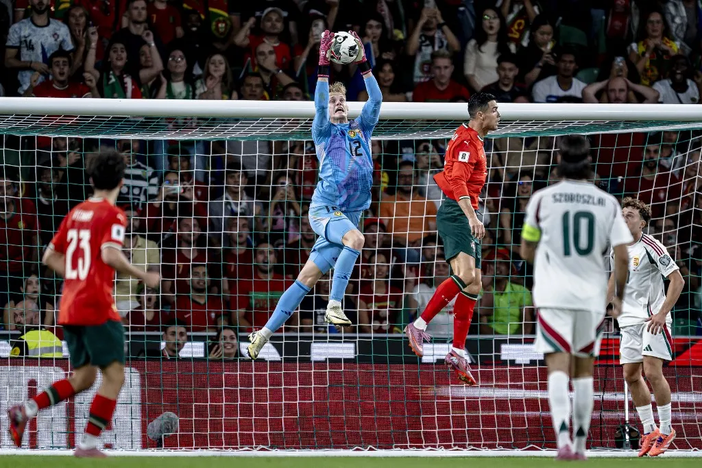 Hungary goalkeeper Balazs Toth and Portugal forward Cristiano Ronaldo play during the match for the FIFA World Cup 2026 UEFA Qualifiers - Group F - Matchday 4 season 2025-2026 at the Estadio Jose Alvalade in Lisbon, Portugal, on October 14, 2025. (Photo by Stefan Koops/EYE4images/NurPhoto) (Photo by Stefan Koops / NurPhoto via AFP)