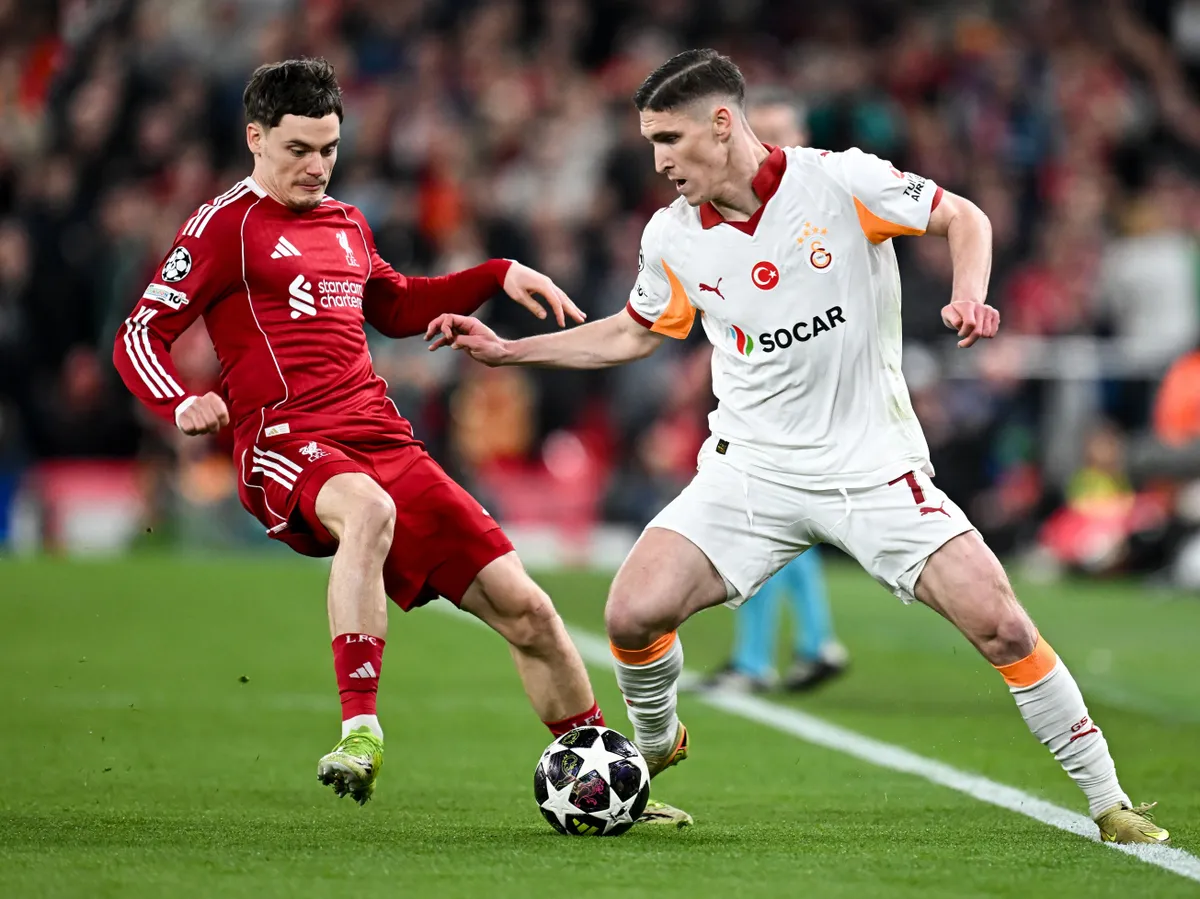 Liverpool's German midfielder #07 Florian Wirtz (L) fights for the ball with Galatasaray's Hungarian forward #07 Roland Sallai during the UEFA Champions League, round of 16 second leg football match between Liverpool and Galatasaray at Anfield in Liverpool, north-west England on March 18, 2026. (Photo by Paul ELLIS / AFP)