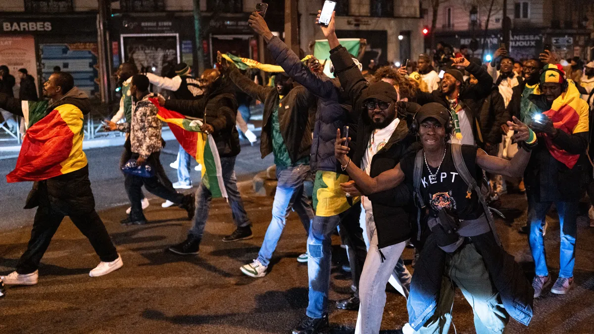 Senegal football supporters celebrate on Boulevard Barbes, at Chateau Rouge, in Paris, France, on January 18, 2026, after Senegal wins the Africa Cup of Nations (CAN) final football match between Senegal and Morocco played in Rabat, Morocco. (Photo by Jerome Gilles/NurPhoto) (Photo by Jerome Gilles / NurPhoto via AFP)