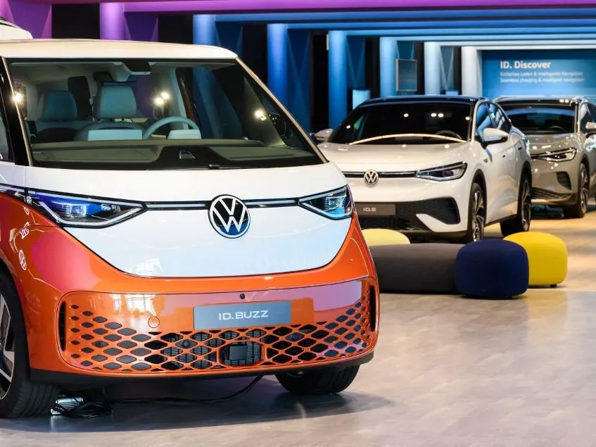 11 May 2022, Lower Saxony, Wolfsburg: A Volkswagen ID.Buzz electric bus and the ID.5 and ID.4 (l-r) electric cars are parked in Autostadt at the Volkswagen main plant. The Annual General Meeting of Volkswagen AG will take place on May 12. Photo: Julian Stratenschulte/dpa (Photo by JULIAN STRATENSCHULTE / dpa Picture-Alliance via AFP)