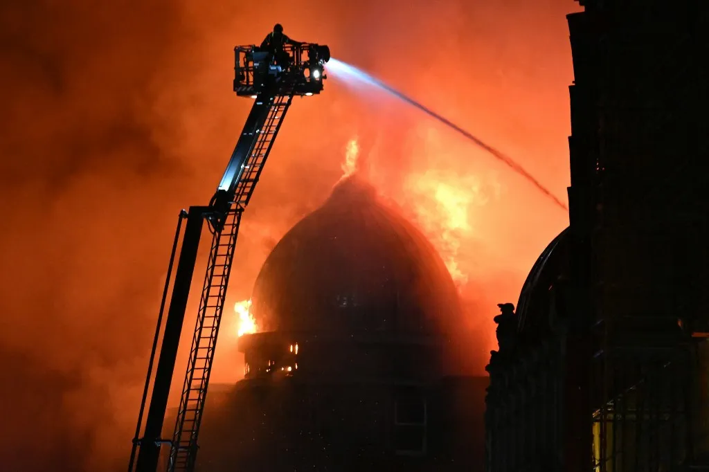 Fire fighters work to control a large fire in Glasgow City centre on March 8, 2026. (Photo by ANDY BUCHANAN / AFP)