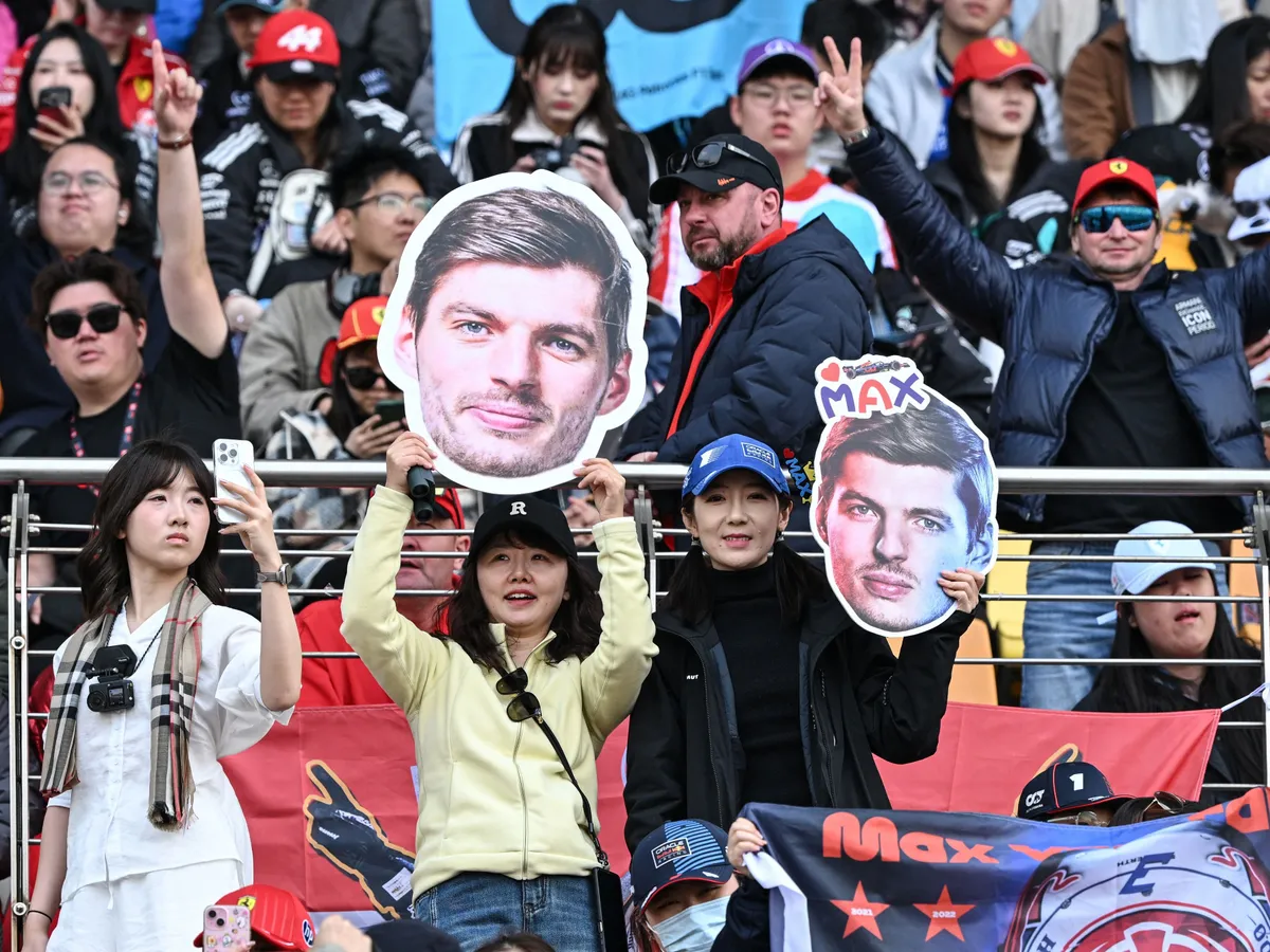Supporters cheers with cut-outs of Red Bull Racing's Dutch driver Max Verstappen prior to the Formula One Chinese Grand Prix at the Shanghai International Circuit in Shanghai on March 15, 2026. (Photo by Greg Baker / AFP)