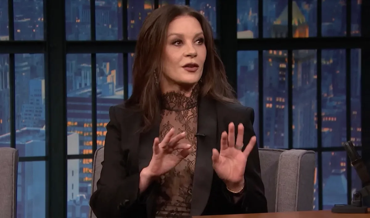 Catherine Zeta-Jones, Picture MUST credit: NBC Wednesday TV show star Catherine Zeta-Jones has told how sword skills she learned in starring in two Zorro movies aided her in the Addams Family spin-off series. Wales-born Zeta-Jones, 55, was speaking on the US Seth Meyers talk show about the latest series of Wednesday in which Catherine plays Morticia Addams, mother of schoolgirl Wednesday Addams played by actress Jenna Ortega, She also revealed that maker Netflix had green lit a third series of the gothic comedy horror show. Meyers reminded Zeta-Jones, woh is married to Basic Instinct star Michael Douglas, 80, she had a fencing scene for the second series and said she “ had a bit of a head start.” He then showed off a film still of her in one of the two swashbuckling Zorro movies about a masked vigilante in early 19th Century California played by Antonio Banderas. She appeared in The Mask of Zorro in1998 and The Legend of Zorro in 2005. Meyers said he understood Ortega had to take fencing lessons but that Catherine had “ a couple Zorros” under her belt. He added: “Is a blade play like riding a bike? You never forget it ?” She replied: “It was like, ‘how are you doing? Need a few rehearsals?’ “I'm like, yeah, OK. “I learned the choreography and the next minute, I was like, ah!” She then pretended to daw and hold out a sword ready to fence. Picture supplied by JLPPA