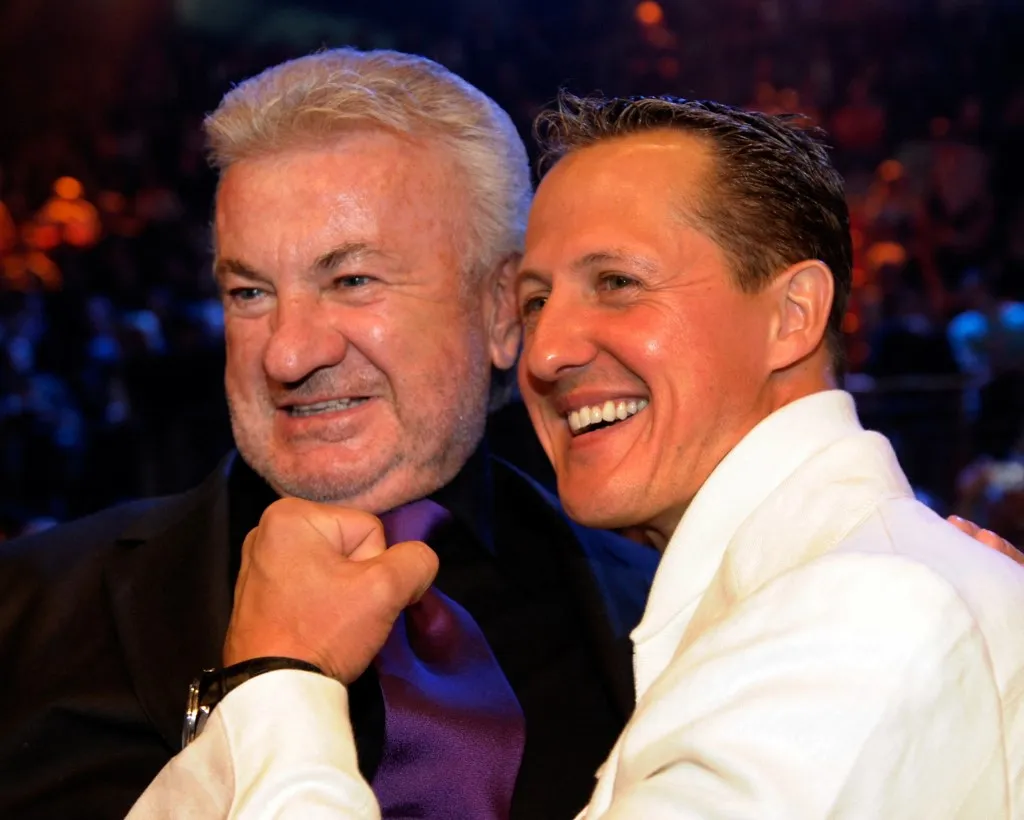 Seven time drivers champion and Ferrari team advisor Michael Schumacher (R) and his former manager Willi Weber attend the WBA middleweight world championship boxing match between German boxer Felix Sturm and Armenian-born German Khoren Gevor at the Nurburgring racetrack on July 11, 2009 in the western German town of Nurburg. Sturm won the fight on points and remains World Champion. AFP PHOTO / SASCHA SCHUERMANN  GERMANY (Photo by SASCHA SCHUERMANN / ddp images via AFP)
