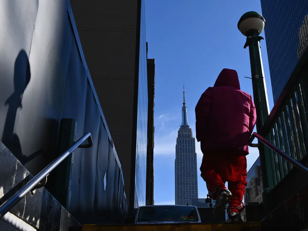 Empire State Building, EmpireStateBuilding, 

A person exits the subway stop near the Empire State Building on January 28, 2021 in New York City. (Photo by Angela Weiss / AFP)