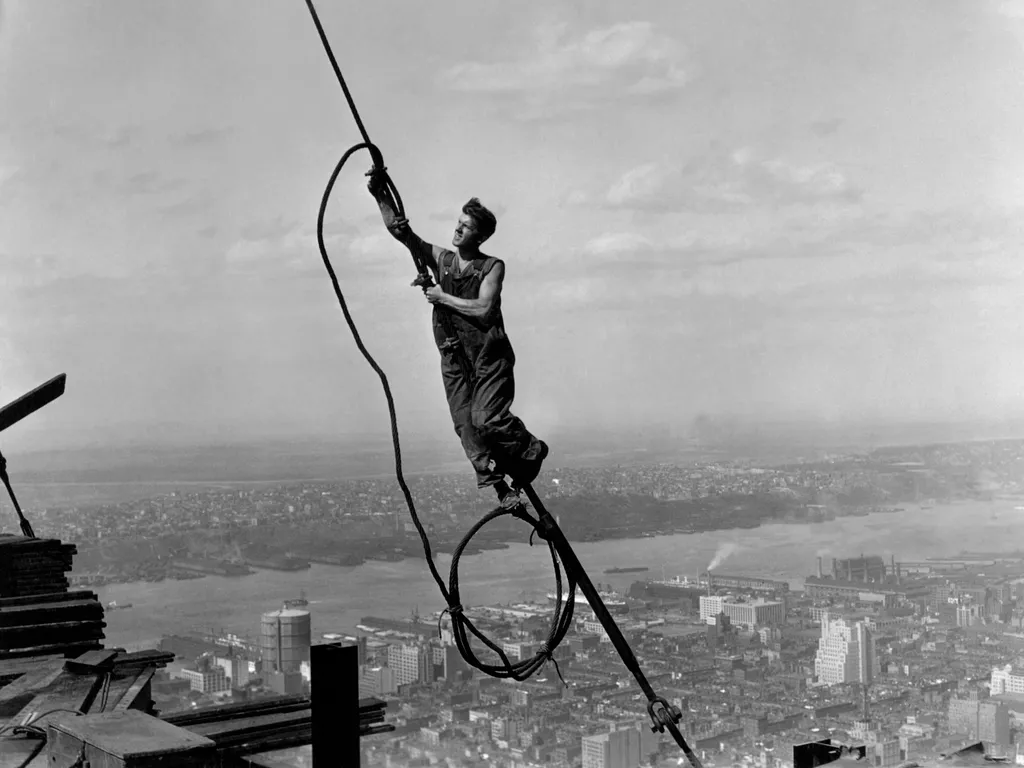 Empire State Building, EmpireStateBuilding, 
  A steelworker dangling in a graceful sangfroid during the construction of the Empire State Building, 1930. (Photo by John Parrot / Lewis Hine / StockTrek Images via AFP)