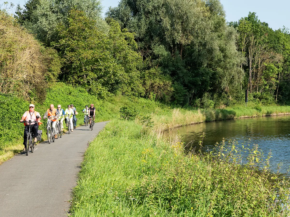 Liedekerke, East Flanders Region, Belgium - 08 28 2021 Group of elderly people driving an electric bike alongside the River Dender, nyaralás
