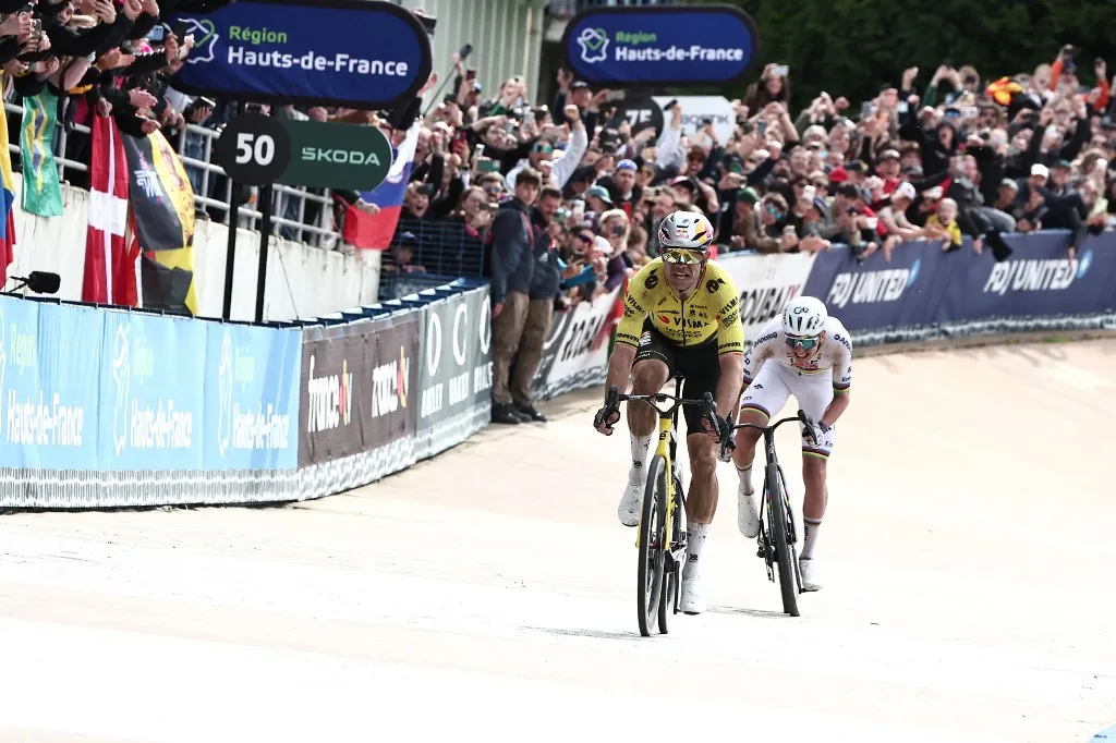 Team Visma - Lease a Bike's Belgian rider Wout van Aert sprints ahead of UAE Team Emirates XRG's Slovenian rider Tadej Pogacar to win the 123rd edition of the Paris-Roubaix one-day classic cycling race, 258.3 km between Compiègne and Roubaix, at the Vélodrome André-Pétrieux in Roubaix, northern France, on April 12, 2026. (Photo by Anne-Christine POUJOULAT / AFP)