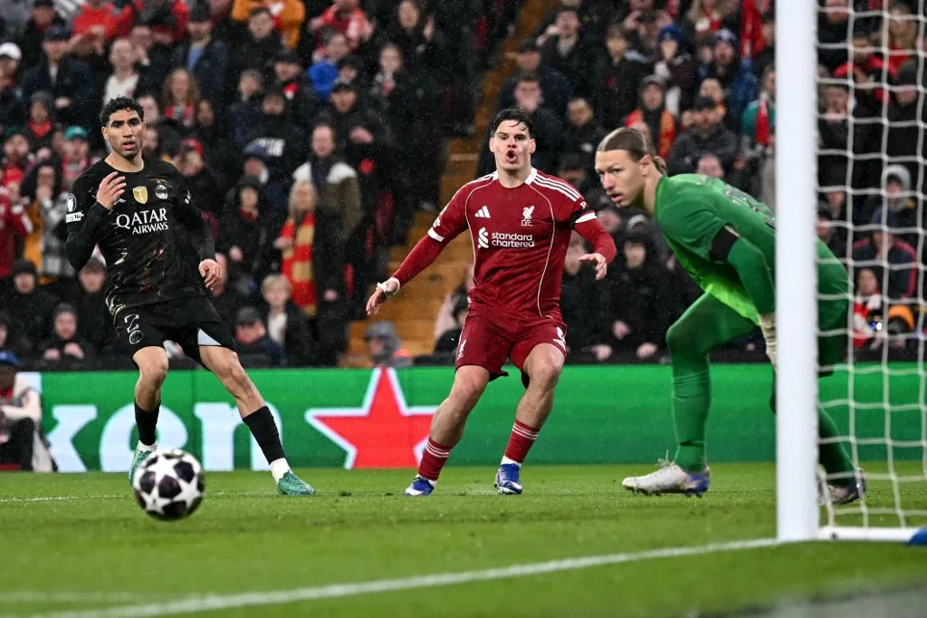 Liverpool's Hungarian defender #06 Milos Kerkez shoots but has the shot saved during the UEFA Champions League quarter final, second-leg football match between Liverpool and Paris Saint-Germain at Anfield in Liverpool, north west England on April 14, 2026. (Photo by Paul ELLIS / AFP)