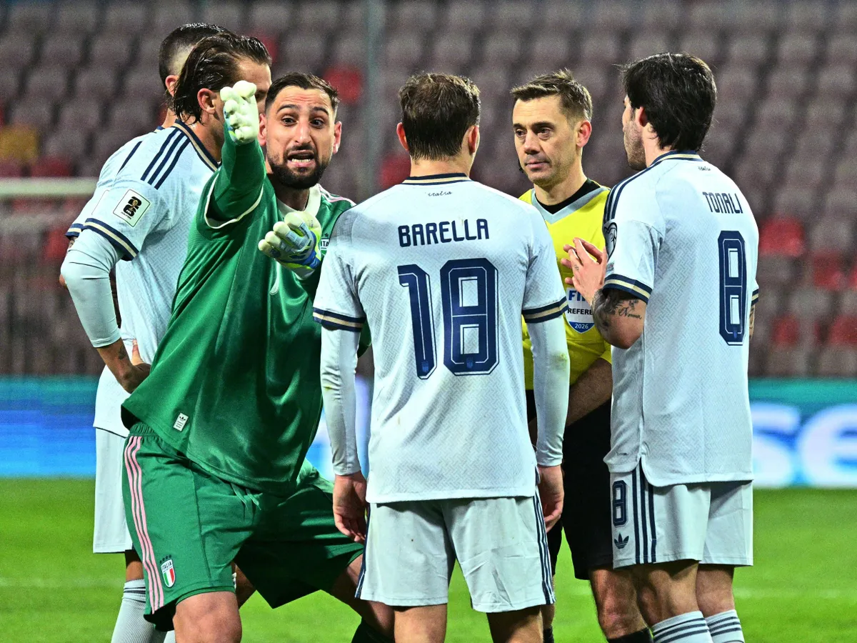 Italy's goalkeeper #01 Gianluigi Donnarumma (L) argues with the referre after Italy's defender #21 Alessandro Bastoni received a red card during the FIFA World Cup 2026 European qualification final football match between Bosnia-Herzegovina and Italy at the Bilino-Polje stadium in Zenica on March 31, 2026. (Photo by Elvis BARUKCIC / AFP)