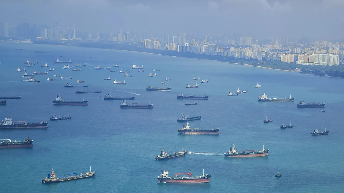 Landscape from bird view of Cargo ships entering one of the busiest ports in the world, Singapore.