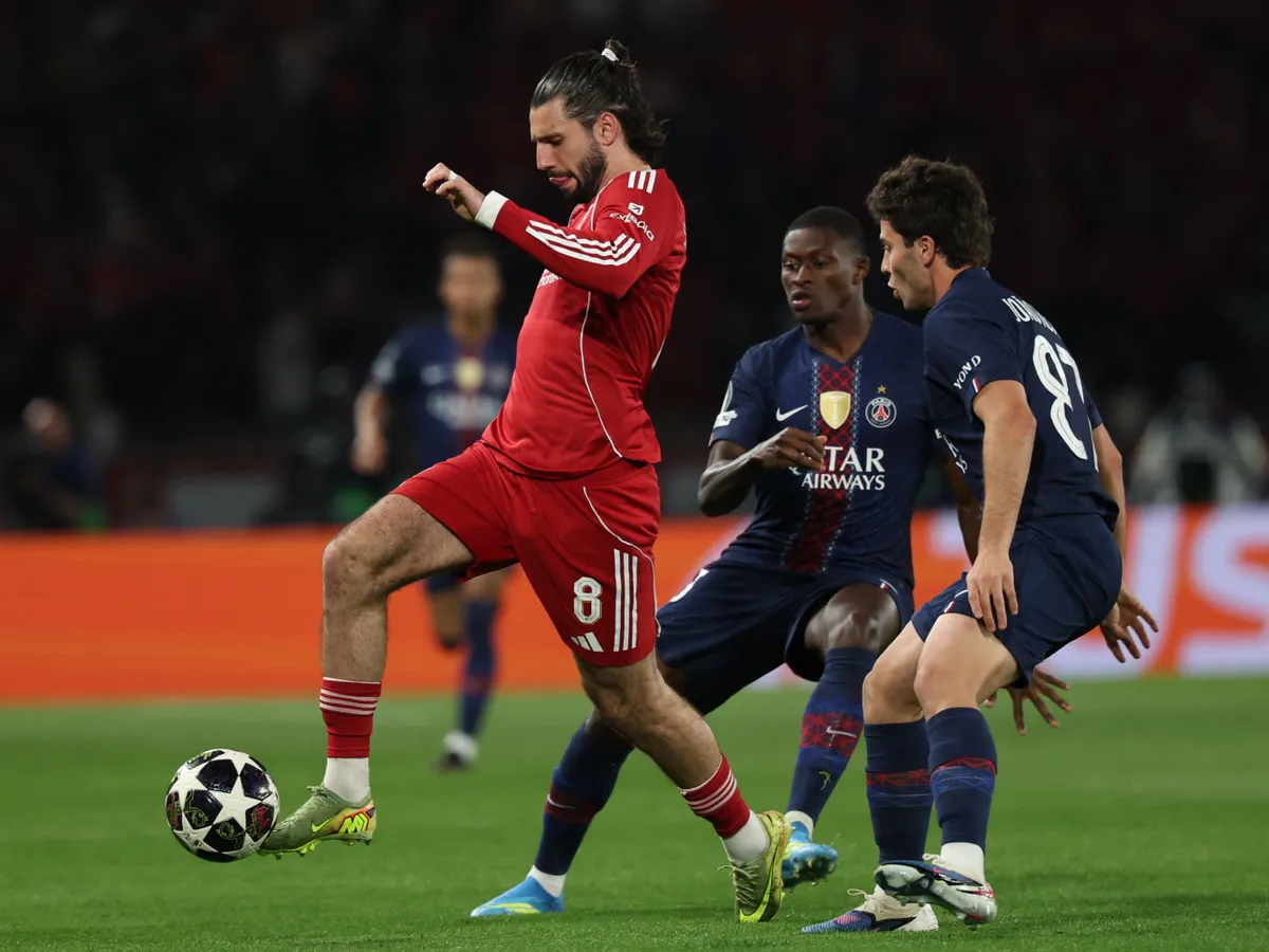 Liverpool's Hungarian midfielder #08 Dominik Szoboszlai (L) fights for the ball with Paris Saint-Germain's Portuguese defender #25 Nuno Mendes and Paris Saint-Germain's Portuguese midfielder #87 Joao Neves during the UEFA Champions League quarter-final first leg football match between Paris Saint-Germain (PSG) and Liverpool FC at the Parc des Princes stadium in Paris on April 8, 2026. (Photo by Anne-Christine POUJOULAT / AFP)