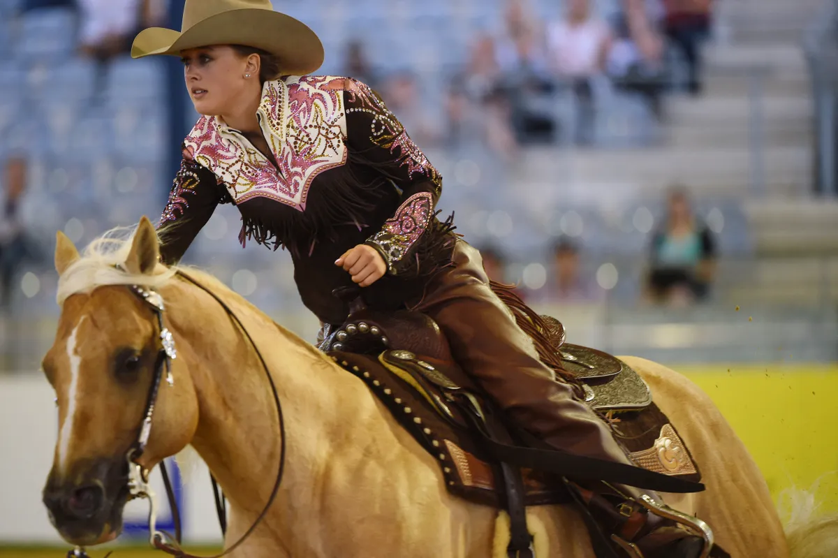 Gina Schumacher, daughter of former German Formula One driver Michael Schumacher, rides on her horse Sharp Dressed Shiner during a presentation of the elements of the reining competition during the FEI European Equestrian Championship 2015 on August 14, 2015 in Aachen, Germany. FEI European Equestrian Championship runs from August 11 to August 23 . AFP PHOTO /  PATRIK STOLLARZ (Photo by PATRIK STOLLARZ / AFP)