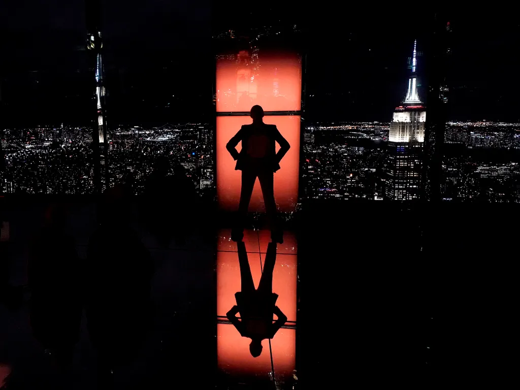 Empire State Building, EmpireStateBuilding, 

Influencer Rachel Wasley poses in a window with the Empire State building in the distance (R) as members of the media attend a press preview to experience SUMMIT by Night ahead of the grand opening of SUMMIT O