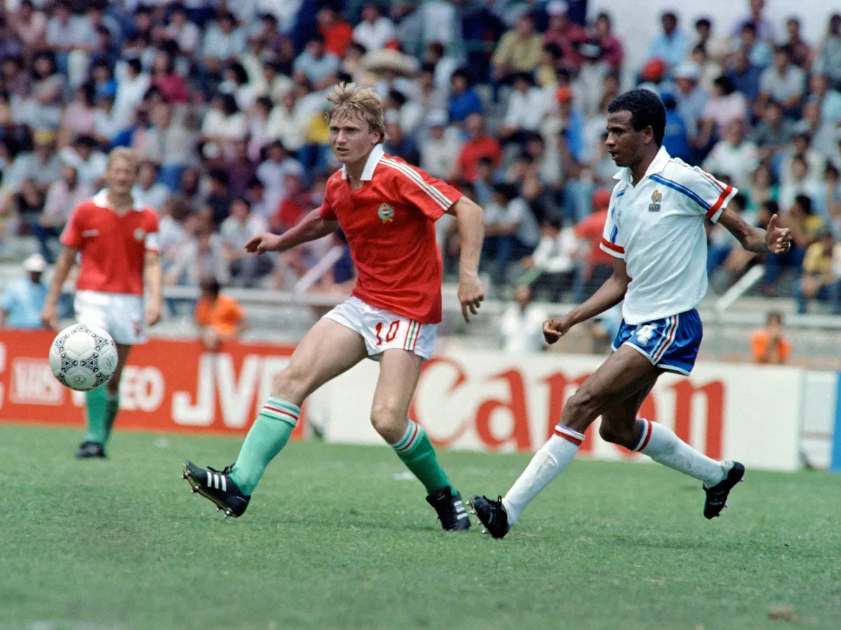 French player Jean Tigana (R) kicks for the ball against his Hungarian opponent Lajos Detari during the World Cup first round soccer match between France and Hungary, 09 June 1986 in Leon. The 1986 FIFA World Cup was the thirteenth edition of the tournament, which is held every four years. Held in Mexico from 31 May to 29 June, it was won by Argentina, led by the 25-year-old Diego Maradona, who was at the peak of his career.&nbsp; (Photo by AFP)