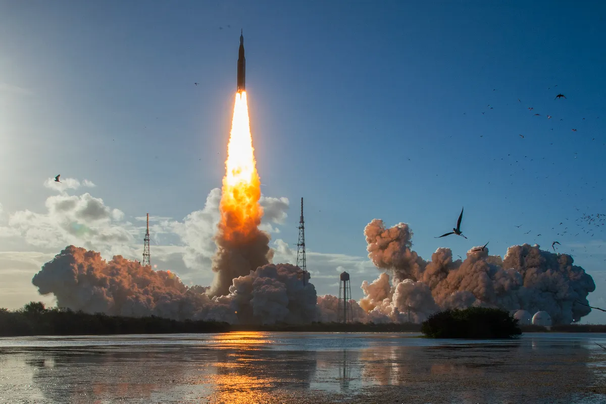The Artemis II crewed lunar mission lifts off from Pad 39B at Kennedy Space Center in Cape Canaveral, Florida, on April 1, 2026. Four astronauts blasted off aboard a massive NASA rocket April 1 on a long-anticipated journey around the Moon, the first crewed lunar flyby in more than 50 years. With an intense roar that reverberated far beyond the launchpad, the enormous orange-and-white rocket carried three Americans and one Canadian away from Florida's Kennedy Space Center at approximately 6:35 pm local time, according to an AFP journalist onsite. "We're going to the Moon!" yelled a spectator. (Photo by Jim WATSON / AFP) / The erroneous mention[s] appearing in the metadata of this photo by Jim WATSON has been modified in AFP systems in the following manner: [---] instead of [---]. Please immediately remove the erroneous mention[s] from all your online services and delete it (them) from your servers. If you have been authorized by AFP to distribute it (them) to third parties, please ensure that the same actions are carried out by them. Failure to promptly comply with these instructions will entail liability on your part for any continued or post notification usage. Therefore we thank you very much for all your attention and prompt action. We are sorry for the inconvenience this notification may cause and remain at your disposal for any further information you may require.