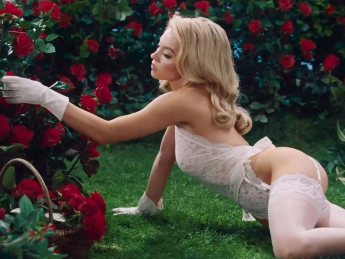 Picture MUST credit: &nbsp;SYRN Actress Sydney Sweeney stars in a new sexy ad for her new lingerie range, set around a garden. The 28-year-old Euphoria and The Housemaid star does chores like pruning and mowing the lawn in her skimpy underwear. The clip starts with her standing in front of a window in a tiny blue-and-white house. Later she wears a black lingerie set as she waters plants and cuts red roses .&nbsp; The clip was posted in the SYRN Instagram page and features items from the brand’s Seductress range. Picture supplied by JLPPA