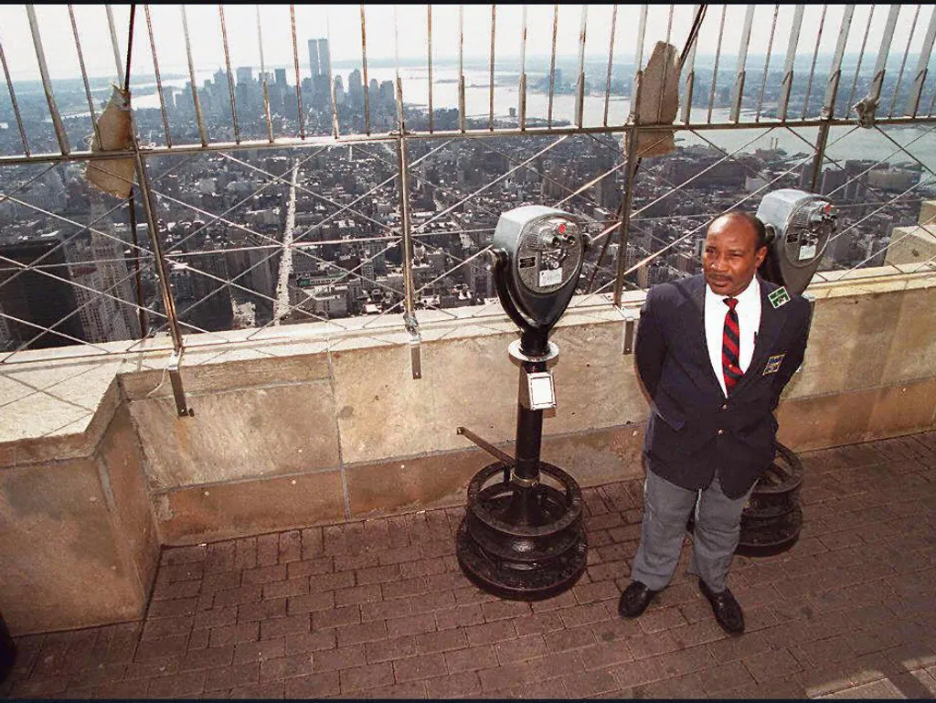 Empire State Building, EmpireStateBuilding, 
  A security guard stands by on the security deck of the Empire State Building 24 February in New York. The observation deck was closed to the public a day after a Palestinian gunman opened fire on tourists vis