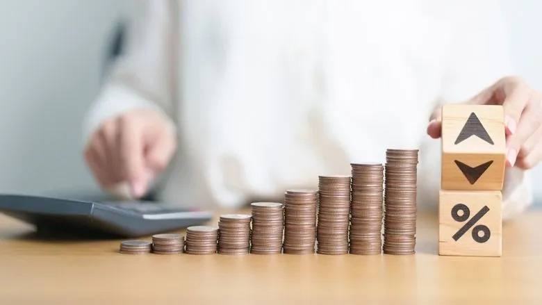 wood block of percentage change to UP and Down arrow with money coins stack. Interest rate, GDP, stocks market, financial, deflation and Inflation, ranking, mortgage, debt, Loan and Economic Recession