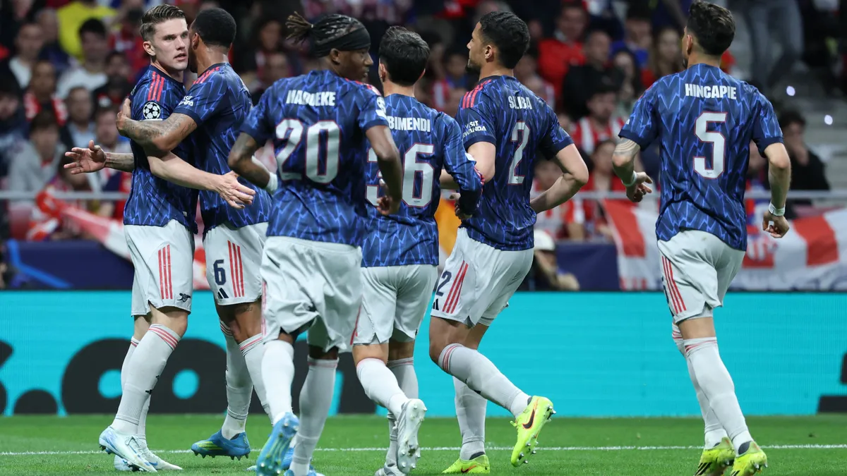 Arsenal players celebrate the opening goal scored by Arsenal's Swedish forward #14 Viktor Gyokeres (L) during the UEFA Champions League semi-final first leg football match between Club Atletico de Madrid and Arsenal at the Metropolitano stadium in Madrid on April 29, 2026. (Photo by Thomas COEX / AFP)