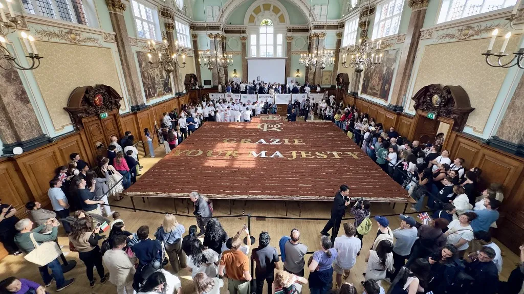 LONDON, UNITED KINGDOM - APRIL 26: A record-breaking tiramisu, measuring 440.58 meters, is displayed at Chelsea Old Town Hall in London, United Kingdom on April 26, 2026. Led by Italian entrepreneur Mirko Ricci and the London branch of the Federation of Italian Chefs, dozens of volunteers collaborated over two days to surpass the previous 273.5-meter record set in Milan in 2019. Guinness World Records official adjudicator Lorenzo Veltri verified the measurement on-site during the event, which was supported by the Italian Embassy and the Italian Cultural Institute. All proceeds from the organization were donated to the Esharelife Foundation to support efforts in combating poverty. Muhammed Yaylali / Anadolu (Photo by Muhammed Yaylali / Anadolu via AFP)